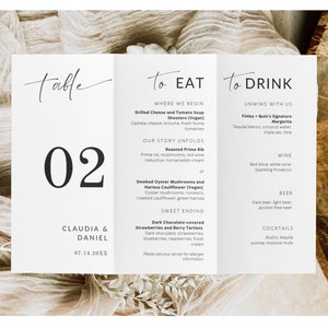 May include: A folded wedding menu card with a minimalist design. The card is white with black text, featuring the table number "02", names, and a wedding menu with food and drink options. The menu includes dishes like Grilled Cheese and Tomato Soup Shooters and Finley Quin's Signature Margarita.