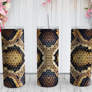 May include: Three stainless steel tumblers with a snake skin pattern. The tumblers are brown, black, and tan.