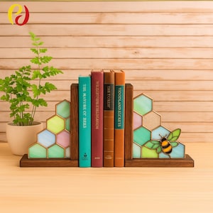 May include: Wooden bookends with a stained glass honeycomb design in pastel colors. A bee graphic is on one bookend. The bookends hold four books with titles including "The Nature of Bees" and "Woodland Secrets".