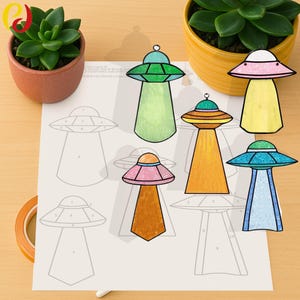 May include: A collection of colorful, stained-glass-style UFO ornaments. Each ornament features a unique color scheme, including green, pink, yellow, orange, and blue. The designs are set against a light background with a printed UFO template.