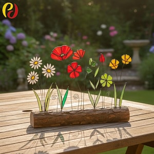 May include: A decorative floral arrangement with vibrant glass flowers, including red poppies, yellow and white daisies, and green leaves. The flowers are set in a rustic wooden log base, ideal for garden or home decor.