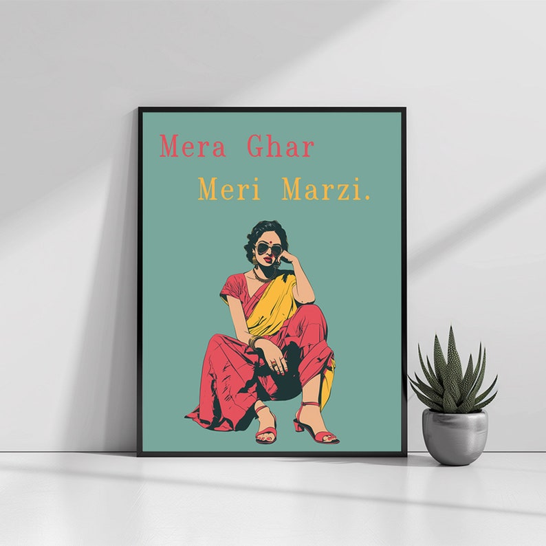 May include: A woman in a red and yellow sari sits with her legs crossed, wearing sunglasses and looking to the side. The text "Mera Ghar Meri Marzi." is written in red and yellow on a teal background.