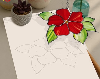 May include: A stained glass flower craft kit featuring a red hibiscus flower design. The kit includes a pattern with numbered sections and a stained glass piece to match.