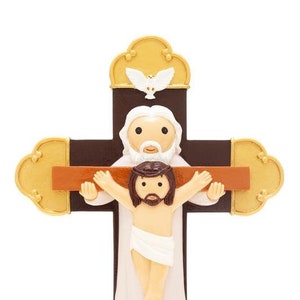 May include: A brown wooden cross with a gold base. A white figure of Jesus is on the cross with a white dove above. The figure of Jesus has a white cloth around the waist.
