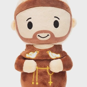 May include: A set of three ceramic mugs with a speckled, matte finish. The mugs are in shades of cream, light brown, and dark brown. Each mug has a simple, minimalist design and a rounded handle.