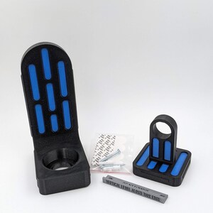 以下が含まれることがあります： ライトセーバー用の円形開口部を持つ、黒と青の3Dプリントされた壁掛け。マウントにはレベルインジケーターが付属しており、取り付け用のネジと粘着ストリップが付属しています。  "VERTICAL LEVEL ALONG THIS EDGE"はレベルインジケーターに印刷されています。