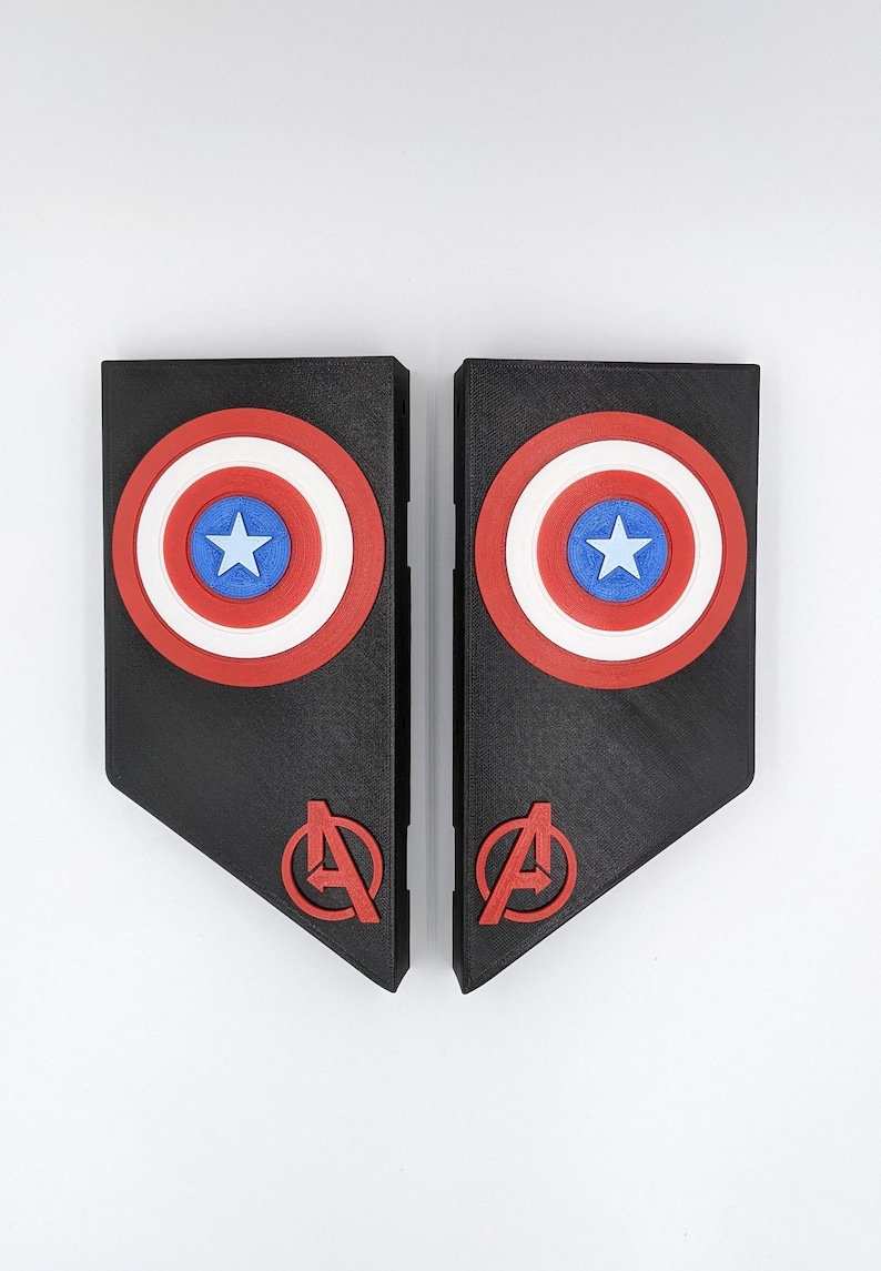May include: Two black 3D printed panels with a red, white, and blue Captain America shield design and a red Avengers logo on each panel.