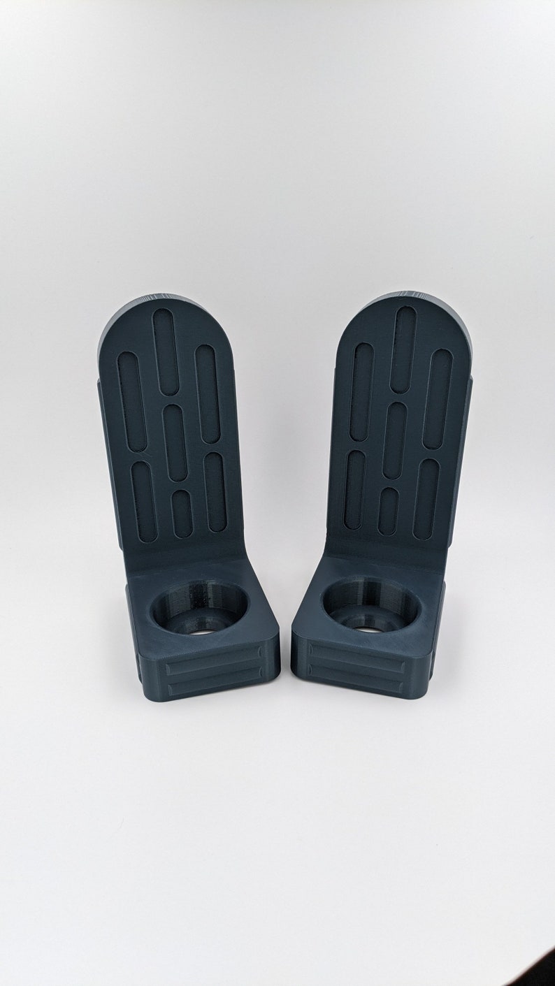 Lightsaber wall mount brackets, 3D printed in high detail PLA Plastic, Star Wars themed to hold and protect your saber while hanging on your wall for display . Available in majority colors and will fit majority of lightsabers on the market today .
