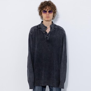 May include: An oversized dark grey sweater with a button-up collar and long sleeves. The sweater is made from a soft, comfortable material and has a relaxed fit.