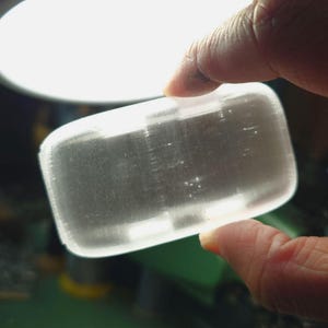 May include: A clear, rectangular, translucent soap bar.