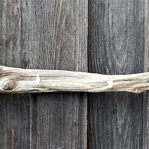 very nice small coat rack made of a driftwood board with white metal hooks 59 cm