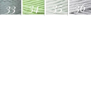 May include: Four skeins of yarn in different colors: light gray, light green, white, and gray. The skeins are labeled with numbers 33, 34, 35, and 36.