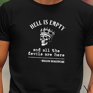 May include: Black t-shirt featuring the quote "HELL IS EMPTY and all the devils are here - WILLIAM SHAKESPEARE" in white. The design includes a skull wearing a crown. The shirt is from Novel Attire.