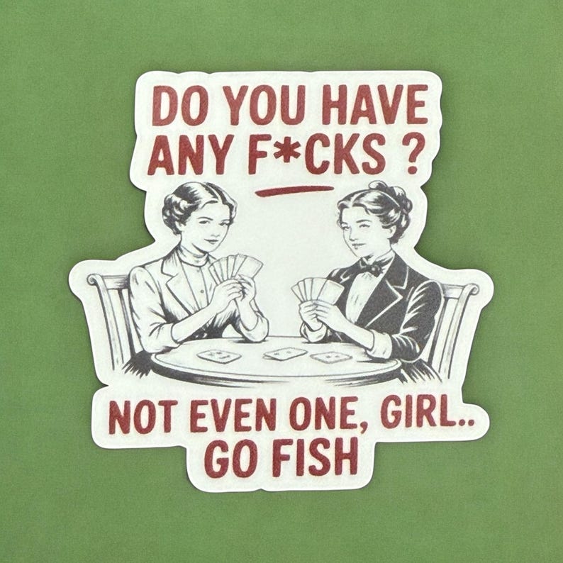 May include: A white sticker with a red border and text. The sticker features two women playing cards with the text "DO YOU HAVE ANY F*CKS? NOT EVEN ONE, GIRL.. GO FISH."