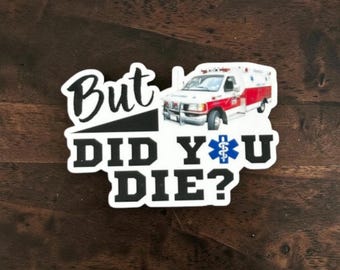 May include: A die-cut sticker featuring a white ambulance with red accents and the text "But DID YOU DIE?" in bold black lettering. The letter O in the word YOU is replaced by a blue Star of Life medical symbol on a white background.