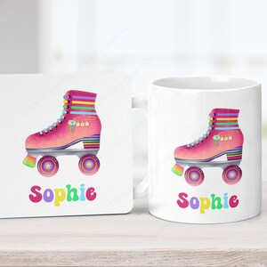May include: A white mug and coaster set featuring a pink roller skate design with rainbow accents. The name "Sophie" is written in colourful letters below the skate. The roller skate has a rainbow heel and wheels.
