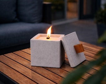 Concrete outdoor fire pit with a great leather handle. Or: The sustainable wax eater!