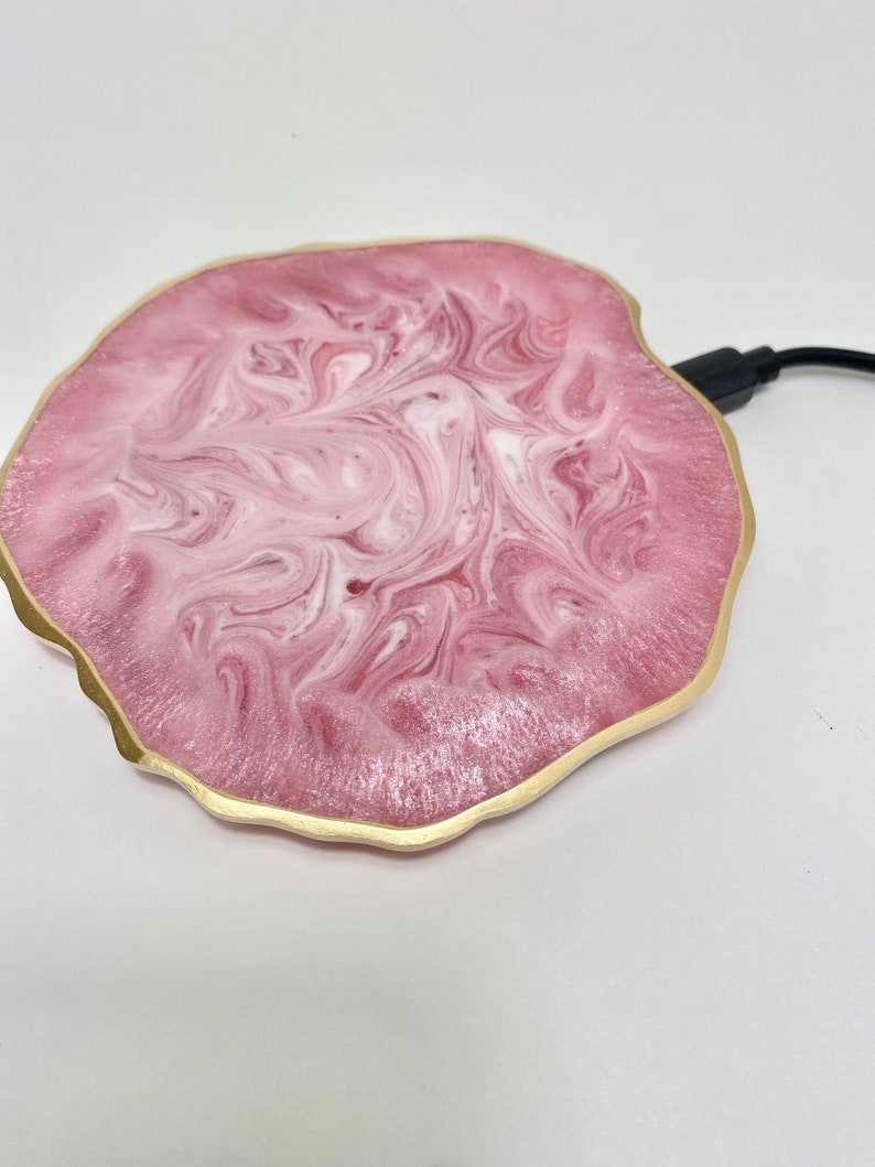  A pink geode wireless charging pad with a gold border