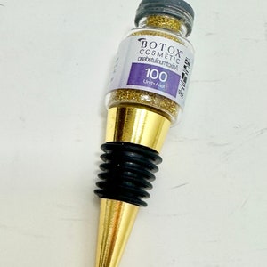 ゴールドのグリッターが輝く樹脂製ボトックスバイアルワインボトルストッパー。素晴らしい注射器、メディカルスパギフト。ユニークで楽しいボトルトッパー。機能的なアート