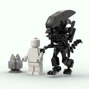 May include: A Lego model of a black Xenomorph alien figure with a white Lego figure and a gray Lego facehugger. The Xenomorph is highly detailed, with a segmented body and a long tail. The facehugger has a yellow center.
