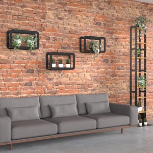 May include: A living room scene with a gray sofa, a brick wall, and black rectangular shelves holding potted plants. A tall black metal shelf unit with wooden shelves also displays plants. The room has a modern, minimalist aesthetic.