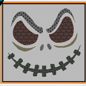 May include: A cross-stitch pattern of a spooky, grinning jack-o'-lantern face with pumpkin-patterned eyes. The face is stitched in black, green, orange, and red thread on a gray background.