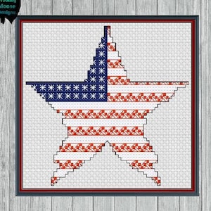 May include: A red, white, and blue American flag in the shape of a star. The star is outlined in blue and has a white background.