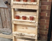 Vertical planter. Ideal for growing herbs veg in a small garden. Flipped upside down the pot holders become pots themselves