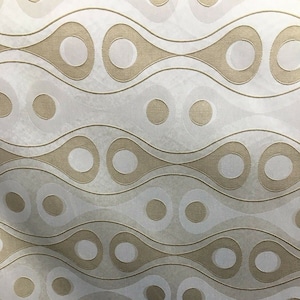 May include: A repeating pattern of beige and off-white teardrop shapes and circles. The design features a wavy, organic layout with the shapes and circles arranged in horizontal rows. The background has a subtle texture.