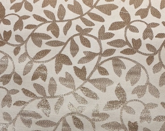 May include: A white fabric with a gold leaf pattern. The leaves are small and delicate, and they are arranged in a repeating pattern.