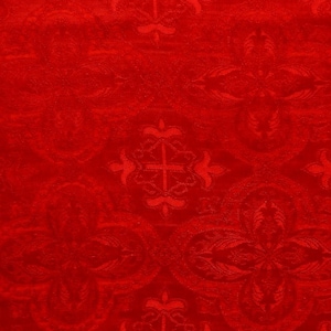 May include: Red fabric with a repeating pattern of stylized crosses and floral designs.