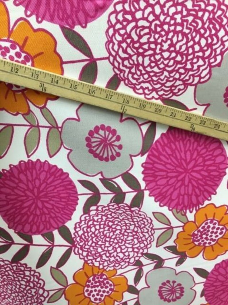 May include: White fabric with a pink, orange, and gray floral pattern. The fabric features large, stylized flowers with a repeating pattern.