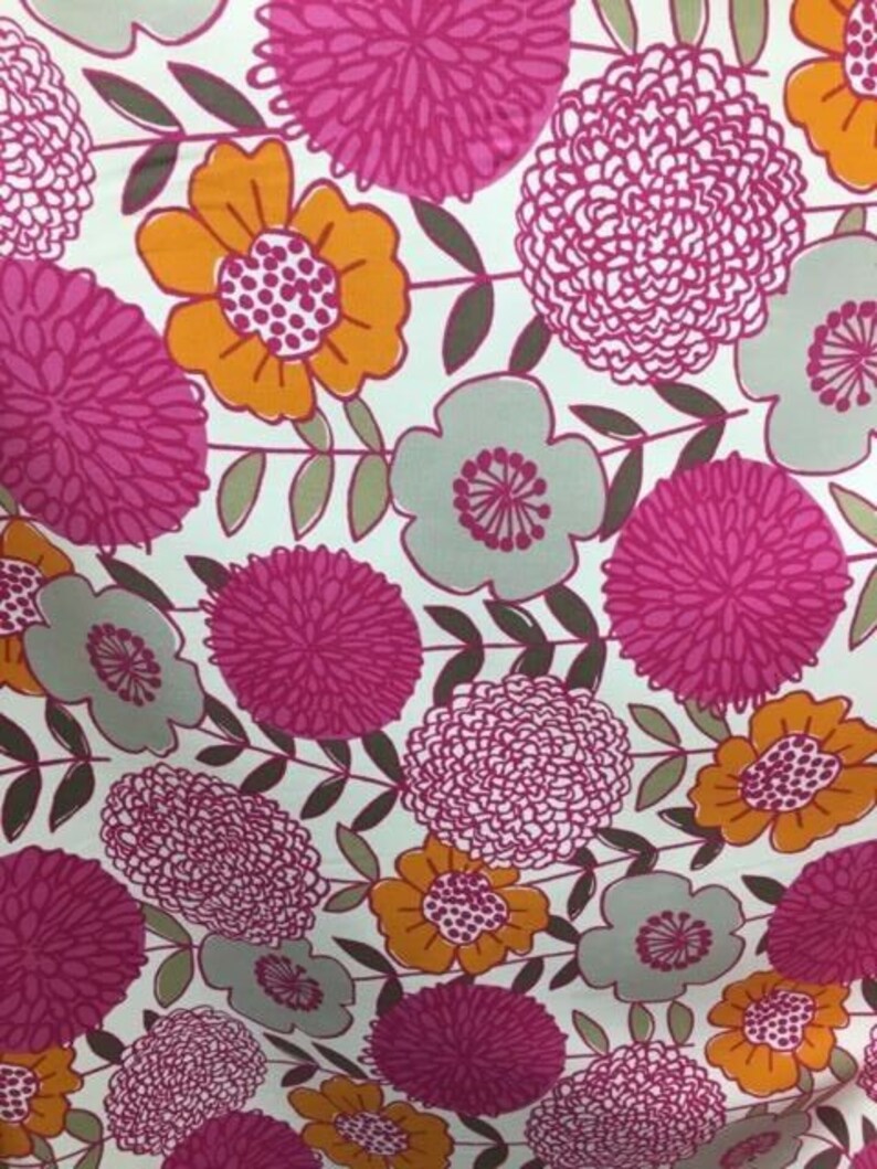 May include: A white fabric with a floral pattern featuring pink, orange, and gray flowers. The flowers are stylized and have a vintage look.