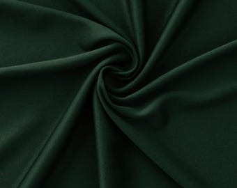 May include: Close-up of a dark green fabric with soft folds and a smooth texture. The fabric is a deep, rich shade of green, with subtle variations in tone due to the folds. The image highlights the fabric's drape and sheen.