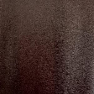 May include: Close-up of a dark brown leather texture. The leather has a pebbled surface and a subtle sheen.