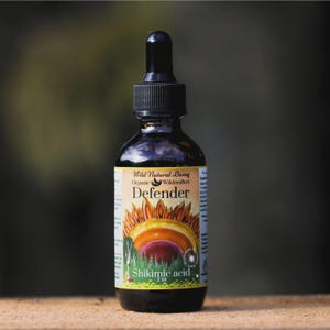 May include: A dark amber glass dropper bottle with a black cap. The label reads Wild Natural Living Organic Wildercrafted Defender Shikimic acid 2 oz, featuring a graphic of a multi-colored mushroom or fungus against a green forest background.