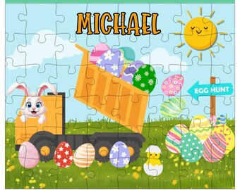 May include: A yellow dump truck with a bunny rabbit peeking out the window. The truck is filled with colorful Easter eggs. The truck is on a green grassy field with a blue sky and a yellow sun. The text "MICHAEL" is written above the truck. A blue sign with the text "EGG HUNT" is on the right side of the image.