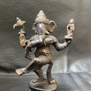 BRONZE GANESH dancing, sculpture of the Hindu god of wisdom, intelligence, Hindu art. Bronze Ganesha god, Hinduist art.