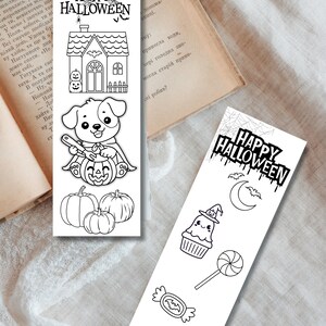 May include: Two Halloween-themed bookmarks with black and white illustrations. One features a house, a dog with a pumpkin, and pumpkins. The other has a cupcake, candy, and the text "HAPPY HALLOWEEN".