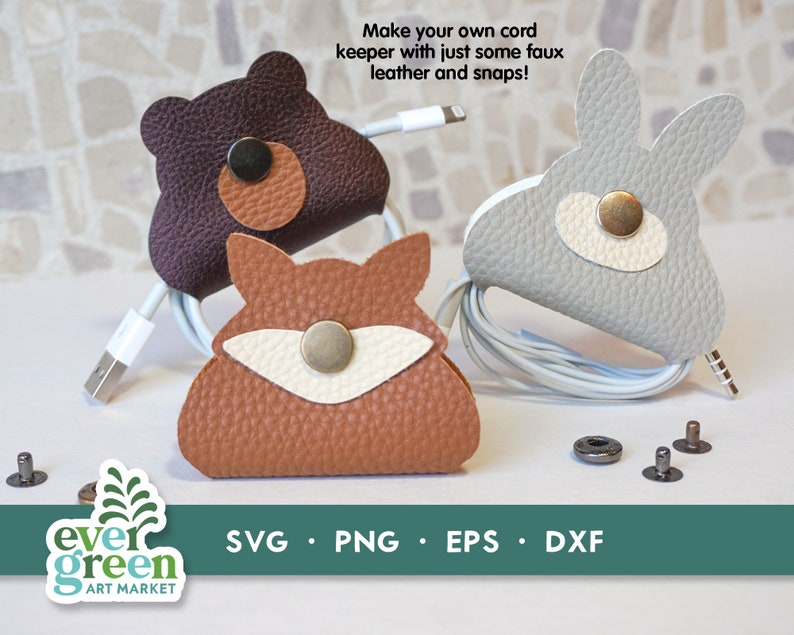 May include: Three faux leather cord keepers shaped like a fox, bear, and bunny. Each keeper has a snap closure and is designed to hold a cord or cable.