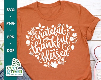 May include: Orange t-shirt with a white graphic design that says "grateful thankful blessed" surrounded by leaves and flowers.