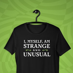 May include: Black t-shirt with white text that reads "I, myself, am strange and unusual".