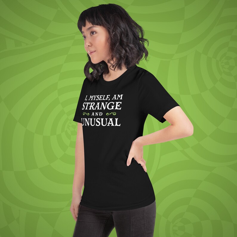May include: Black t-shirt with white text that reads "I, myself, am strange and unusual" with a decorative swirl design on either side of the word "and".
