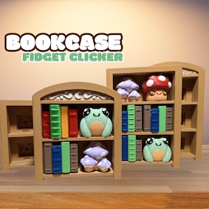 May include: Wooden bookcase fidget clicker with colorful books, a frog, and mushroom figurines. The bookcase has a light brown finish and the text "BOOKCASE FIDGET CLICKER" in a playful font.