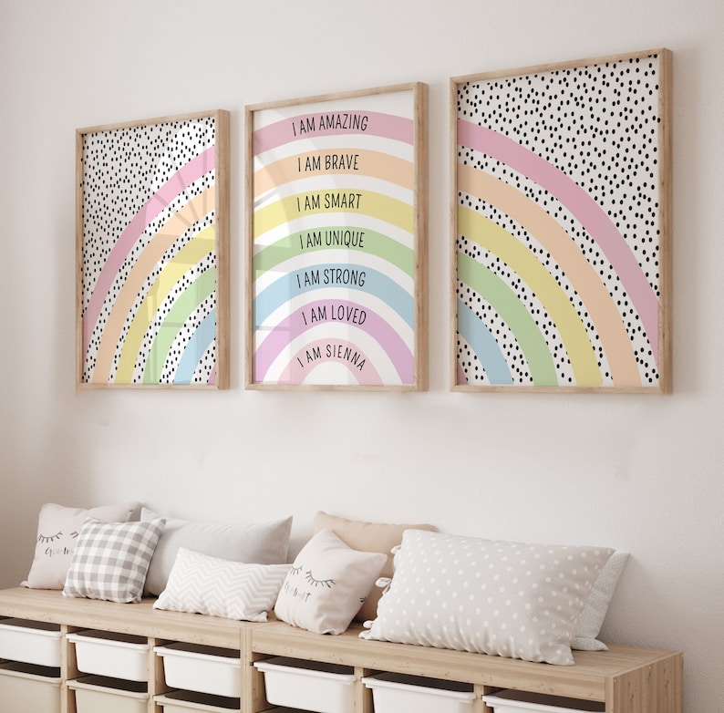 May include: Three framed art prints with rainbow designs and inspirational text. The center print reads "I AM AMAZING, I AM BRAVE, I AM SMART, I AM UNIQUE, I AM STRONG, I AM LOVED, I AM SIENNA." The other two prints feature rainbow patterns and black polka dots.