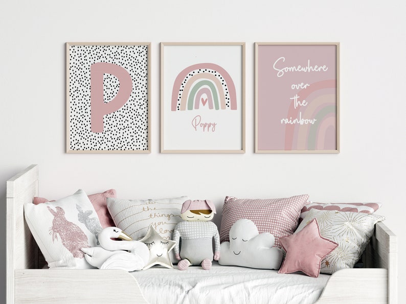 May include: Three framed art prints with a nursery theme. One features a pink letter "P" on a black and white polka dot background. Another displays a rainbow with the name "Poppy". The third says "Somewhere over the rainbow".