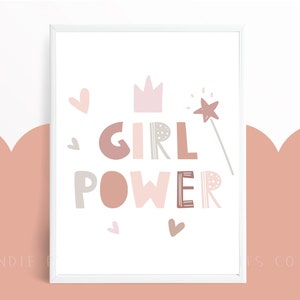 May include: A framed print with the words "GIRL POWER" in various shades of pink, brown, and gray. The design includes a crown, hearts, and a star-tipped wand. The background is white with a pink and white scalloped design.