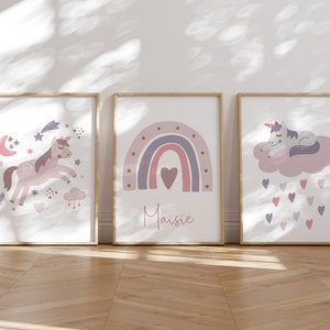May include: Three framed art prints with a whimsical unicorn theme. The prints feature a unicorn, a rainbow with the name "Maisie", and a sleeping unicorn on a cloud. Soft pastel colors and a wooden frame.