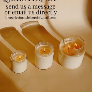 three candles sitting on top of a table next to each other