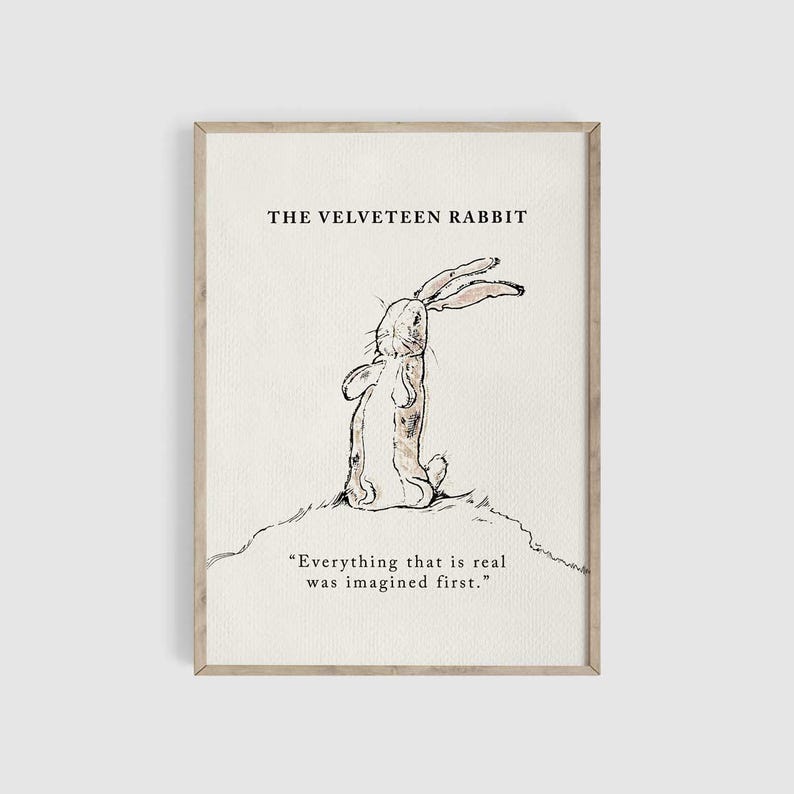 May include: A framed print featuring a sketch of a rabbit from "The Velveteen Rabbit." The rabbit is drawn in black ink, sitting on a small hill. The text "THE VELVETEEN RABBIT" is above the rabbit, and a quote is below.